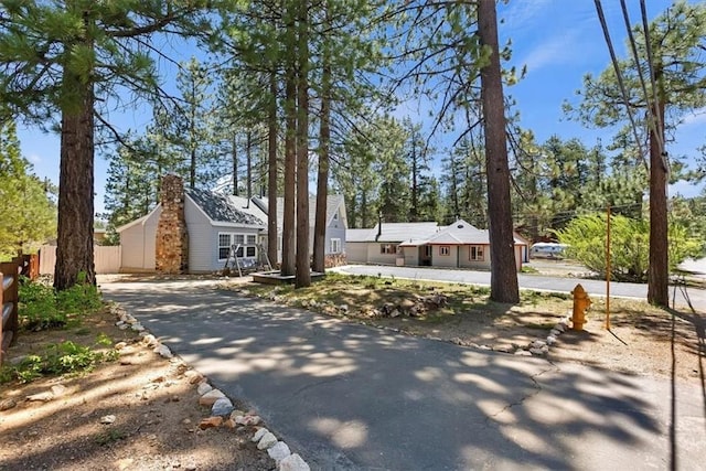 681 Chipmunk Ln, Big Bear Lake, CA 92315 - view of front of property featuring driveway and a chimney