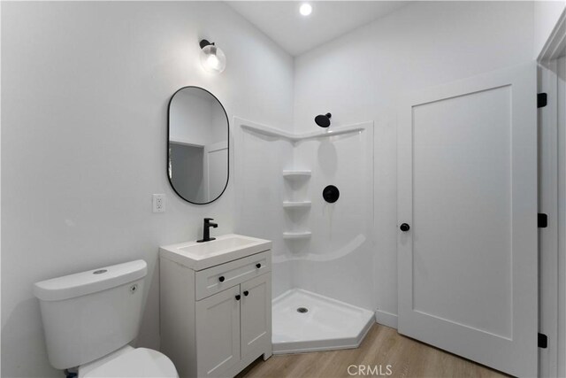 752 E 17th St, Los Angeles, CA 90021 - bathroom featuring wood finished floors, a shower stall, vanity, and toilet