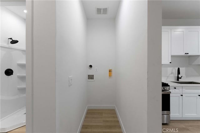 752 E 17th St, Los Angeles, CA 90021 - washroom with washer hookup, light wood-type flooring, and baseboards