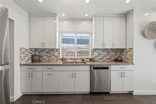 5834 Satsuma Ave, North Hollywood, CA 91601 - kitchen with appliances with stainless steel finishes, a sink, light countertops, white cabinetry, and recessed lighting