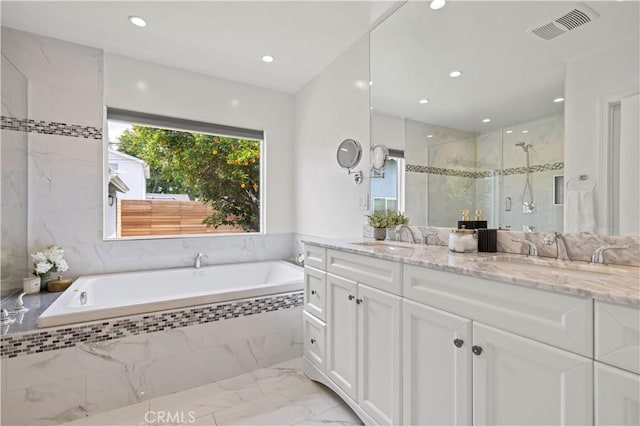 5834 Satsuma Ave, North Hollywood, CA 91601 - bathroom featuring marble finish flooring, double vanity, a garden tub, a marble finish shower, and recessed lighting
