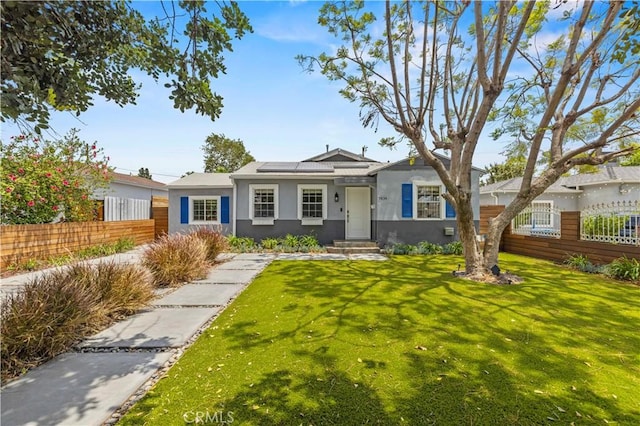 5834 Satsuma Ave, North Hollywood, CA 91601 - view of front of home featuring stucco siding and roof mounted solar panels