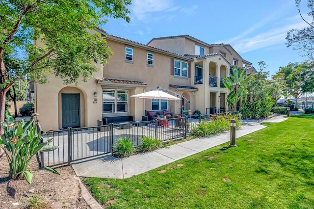 4300 Newton Ave Unit 110, San Diego, CA 92113 - rear view of property featuring stucco siding, a tiled roof, and a patio