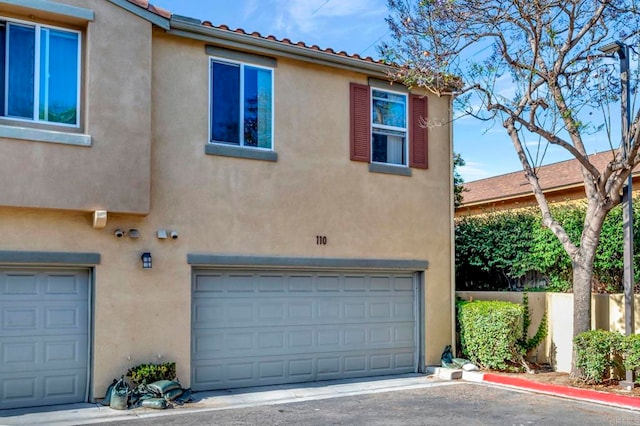 4300 Newton Ave Unit 110, San Diego, CA 92113 - view of front of property with stucco siding and an attached garage
