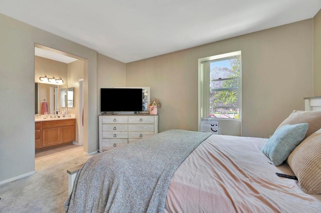 4300 Newton Ave Unit 110, San Diego, CA 92113 - bedroom featuring light carpet, ensuite bathroom, baseboards, and a sink