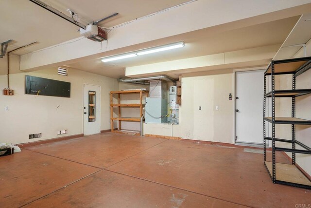 513 Shadow Tree Dr, Oceanside, CA 92058 - garage with heating unit, a garage door opener, and baseboards