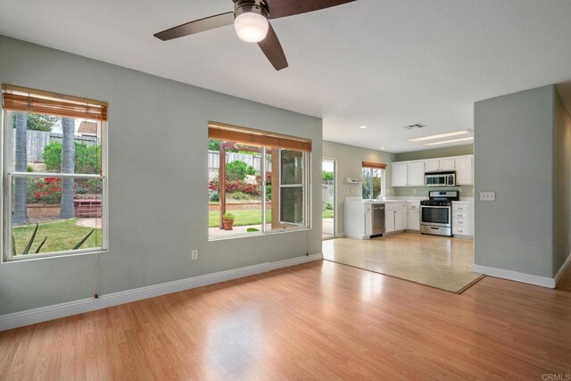 513 Shadow Tree Dr, Oceanside, CA 92058 - unfurnished living room with baseboards, light wood finished floors, and a ceiling fan