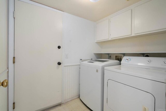 513 Shadow Tree Dr, Oceanside, CA 92058 - washroom featuring washing machine and dryer, cabinet space, wainscoting, and light flooring