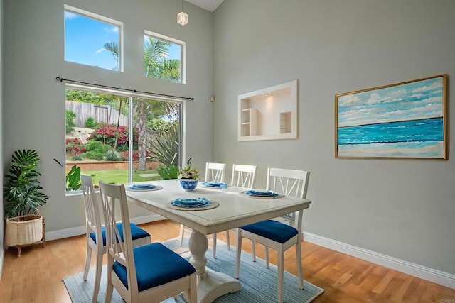 513 Shadow Tree Dr, Oceanside, CA 92058 - dining room featuring a high ceiling, baseboards, and light wood finished floors