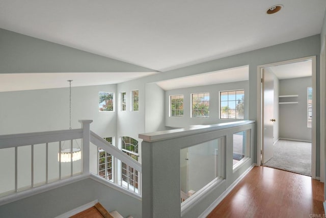 513 Shadow Tree Dr, Oceanside, CA 92058 - corridor featuring plenty of natural light, wood finished floors, an upstairs landing, baseboards, and lofted ceiling