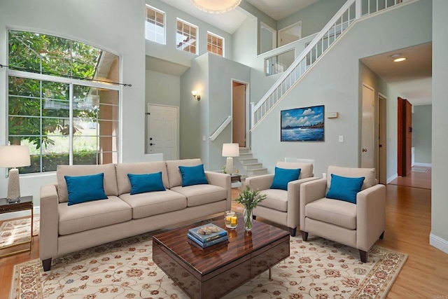 513 Shadow Tree Dr, Oceanside, CA 92058 - living room with wood finished floors, plenty of natural light, stairs, and a high ceiling