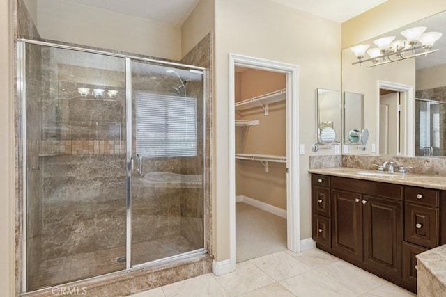 4224 Oliphant Ct, Riverside, CA 92505 - bathroom with vanity, a chandelier, a shower stall, and a walk in closet