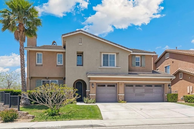 4224 Oliphant Ct, Riverside, CA 92505 - view of front of home featuring an attached garage, driveway, stucco siding, and stone siding