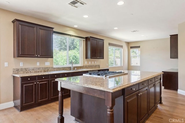 4224 Oliphant Ct, Riverside, CA 92505 - kitchen with a sink, plenty of natural light, baseboards, light wood-style flooring, and recessed lighting
