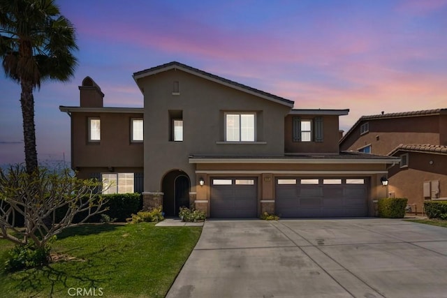 4224 Oliphant Ct, Riverside, CA 92505 - view of front of house with concrete driveway, a garage, a chimney, a front yard, and stucco siding