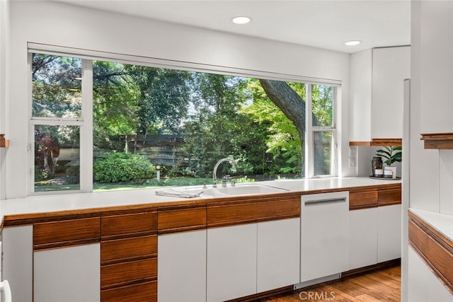 1671 Plumas Way, Chico, CA 95926 - kitchen featuring dishwasher, light countertops, a sink, white cabinetry, and recessed lighting