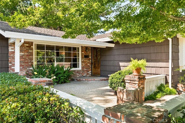 1671 Plumas Way, Chico, CA 95926 - doorway to property featuring brick siding and roof with shingles