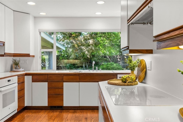 1671 Plumas Way, Chico, CA 95926 - kitchen featuring white appliances, light countertops, ventilation hood, white cabinetry, and recessed lighting