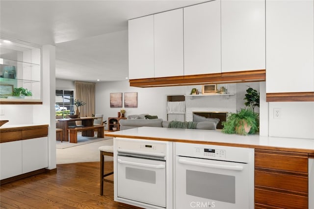 1671 Plumas Way, Chico, CA 95926 - kitchen featuring white oven, white cabinetry, light countertops, dark wood-style flooring, and recessed lighting