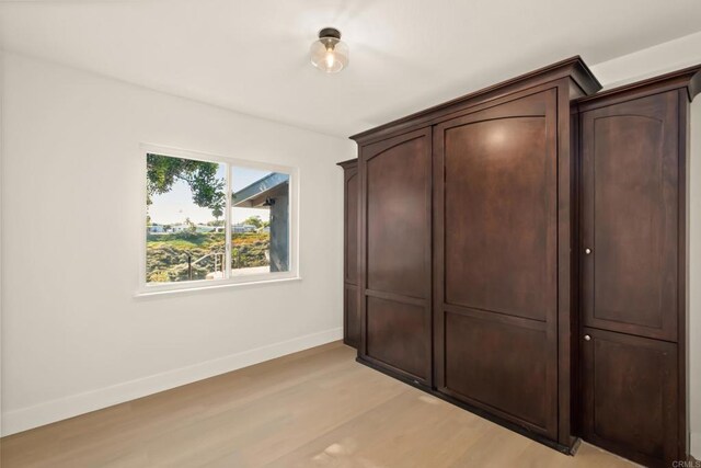 4158 Seri St, San Diego, CA 92117 - unfurnished bedroom with light wood-style flooring, baseboards, and a closet
