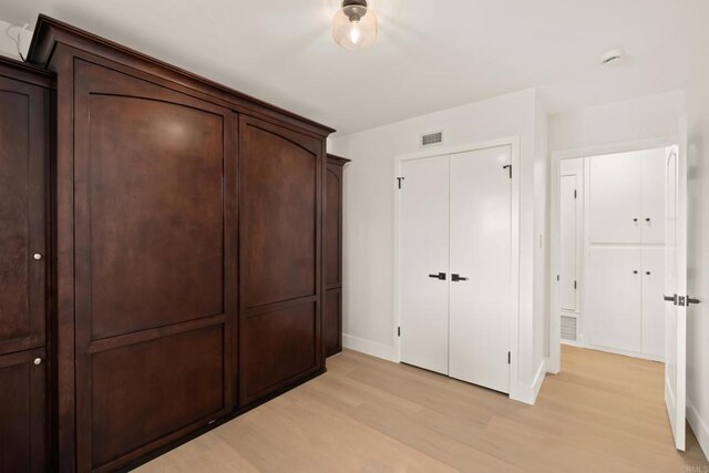 4158 Seri St, San Diego, CA 92117 - unfurnished bedroom featuring light wood finished floors, baseboards, and a closet