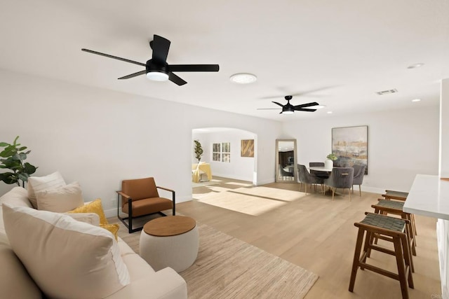 4158 Seri St, San Diego, CA 92117 - living room with a ceiling fan, baseboards, arched walkways, and light wood-type flooring