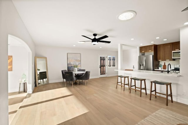 4158 Seri St, San Diego, CA 92117 - living area featuring a ceiling fan, light wood-style floors, baseboards, recessed lighting, and arched walkways