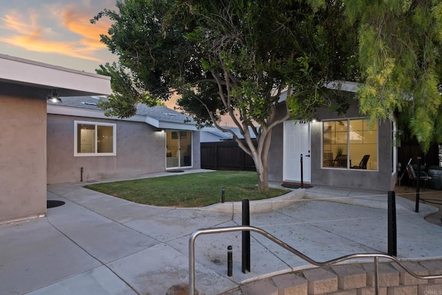 4158 Seri St, San Diego, CA 92117 - back of house at dusk featuring stucco siding, a patio area, and an outdoor structure