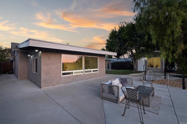 4158 Seri St, San Diego, CA 92117 - back of property at dusk with a patio area and stucco siding