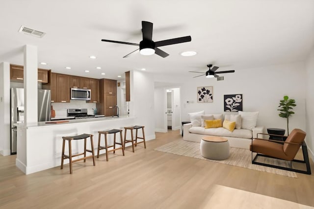 4158 Seri St, San Diego, CA 92117 - living room featuring light wood-type flooring, recessed lighting, ceiling fan, and baseboards