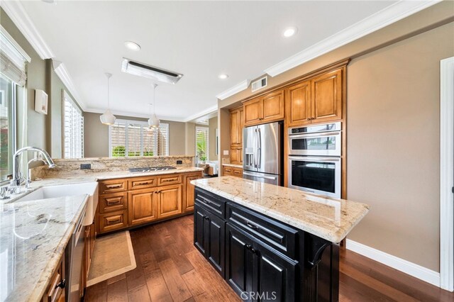 16139 Crooked Creek Ct, Chino Hills, CA 91709 - kitchen with appliances with stainless steel finishes, ornamental molding, dark cabinetry, brown cabinets, and a sink