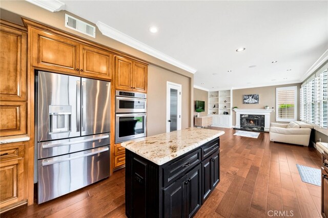 16139 Crooked Creek Ct, Chino Hills, CA 91709 - kitchen with stainless steel appliances, brown cabinets, dark cabinetry, built in features, and dark wood-style flooring