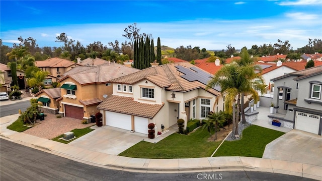 16139 Crooked Creek Ct, Chino Hills, CA 91709 - mediterranean / spanish-style house featuring driveway, a tiled roof, stucco siding, an attached garage, and a residential view