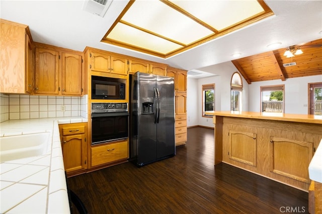 22635 Juanita Ct, Red Bluff, CA 96080 - kitchen with black appliances, tile counters, dark wood-type flooring, backsplash, and lofted ceiling