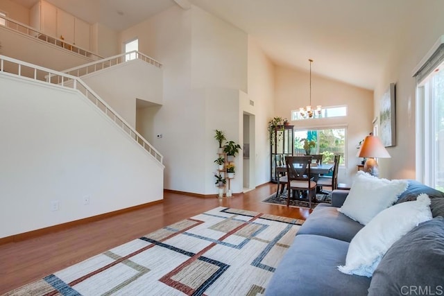 543 Boysenberry Way, Oceanside, CA 92057 - living area with a chandelier, wood finished floors, baseboards, high vaulted ceiling, and stairs