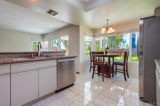 543 Boysenberry Way, Oceanside, CA 92057 - kitchen featuring appliances with stainless steel finishes, a sink, baseboards, a chandelier, and light tile patterned floors