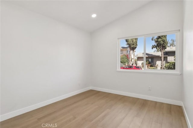 12548 Terra Bella St, Pacoima, CA 91331 - empty room featuring baseboards, light wood-style floors, lofted ceiling, and recessed lighting