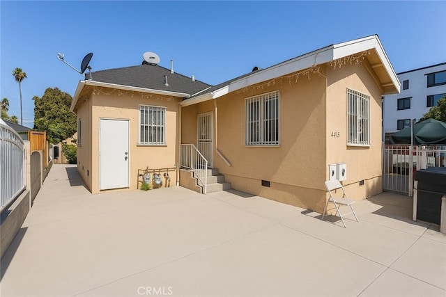 4415 Mettler St Unit 4413, Los Angeles, CA 90011 - back of house featuring a patio area, stucco siding, and crawl space