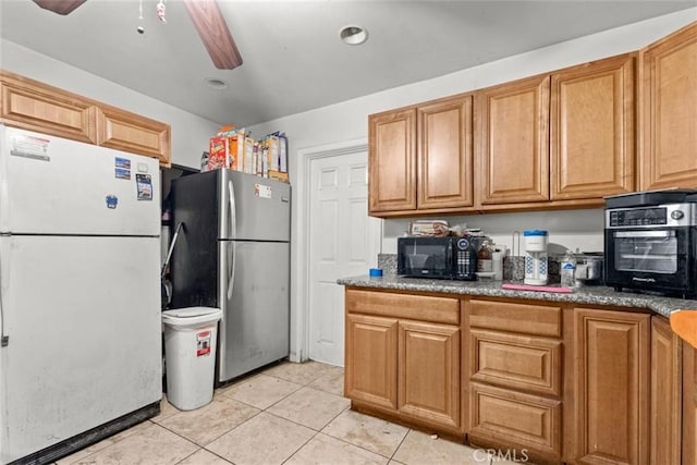 4415 Mettler St Unit 4413, Los Angeles, CA 90011 - kitchen featuring freestanding refrigerator, black microwave, light tile patterned floors, and ceiling fan