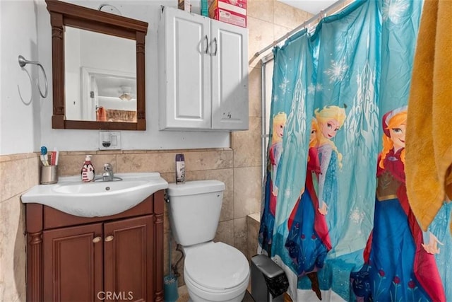 4415 Mettler St Unit 4413, Los Angeles, CA 90011 - bathroom with tile walls, vanity, toilet, and curtained shower