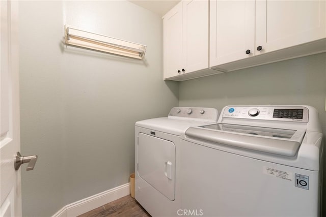 26121 Calle Cresta, Mission Viejo, CA 92692 - washroom featuring cabinet space, washing machine and clothes dryer, baseboards, and wood finished floors
