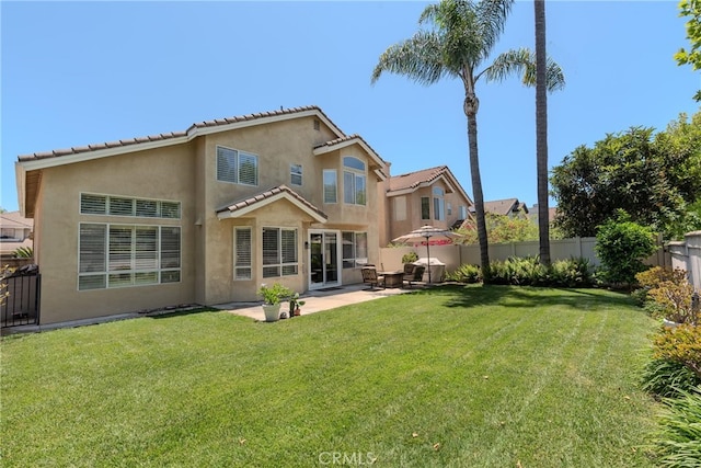 26121 Calle Cresta, Mission Viejo, CA 92692 - back of property with stucco siding, a patio area, and a tiled roof