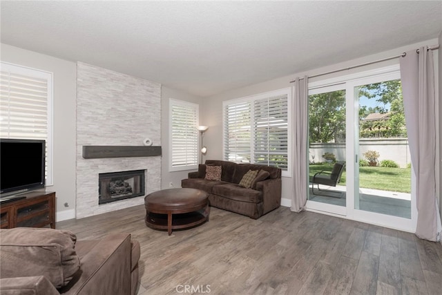 26121 Calle Cresta, Mission Viejo, CA 92692 - living room featuring wood finished floors, a fireplace, and baseboards