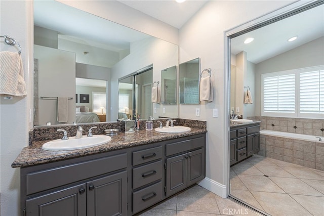 26121 Calle Cresta, Mission Viejo, CA 92692 - ensuite bathroom featuring double vanity, tile patterned floors, a bath, and lofted ceiling