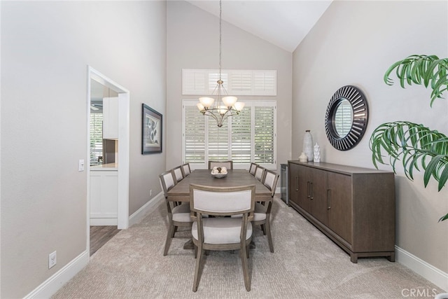 26121 Calle Cresta, Mission Viejo, CA 92692 - dining room with a chandelier, plenty of natural light, baseboards, light colored carpet, and high vaulted ceiling
