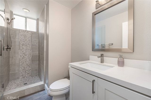 26121 Calle Cresta, Mission Viejo, CA 92692 - bathroom featuring toilet, vanity, a tile shower, and wood finished floors