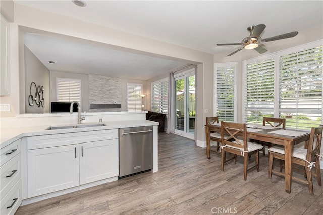 26121 Calle Cresta, Mission Viejo, CA 92692 - kitchen featuring stainless steel dishwasher, a sink, light wood-style floors, a ceiling fan, and open floor plan