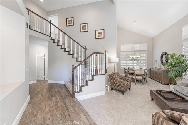 26121 Calle Cresta, Mission Viejo, CA 92692 - entrance foyer with high vaulted ceiling, a chandelier, wood finished floors, stairs, and baseboards