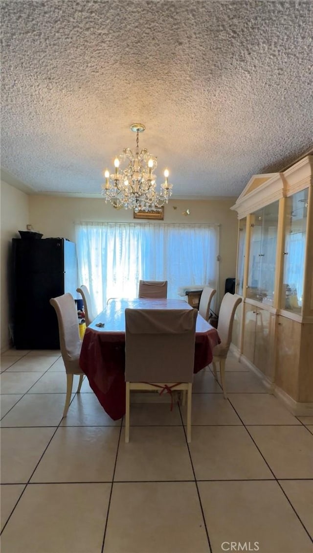 8758 S Hobart Blvd, Los Angeles, CA 90047 - dining room with a chandelier, light tile patterned floors, and a textured ceiling