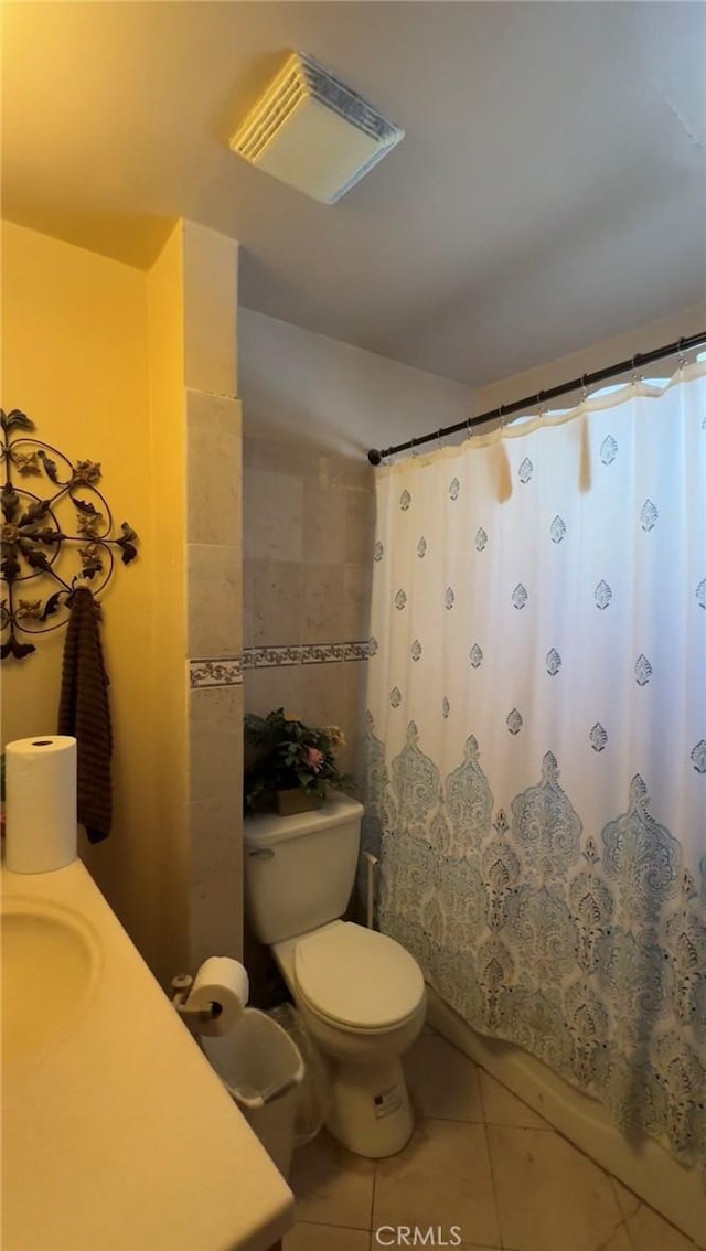 8758 S Hobart Blvd, Los Angeles, CA 90047 - bathroom with tile patterned floors, vanity, toilet, and curtained shower